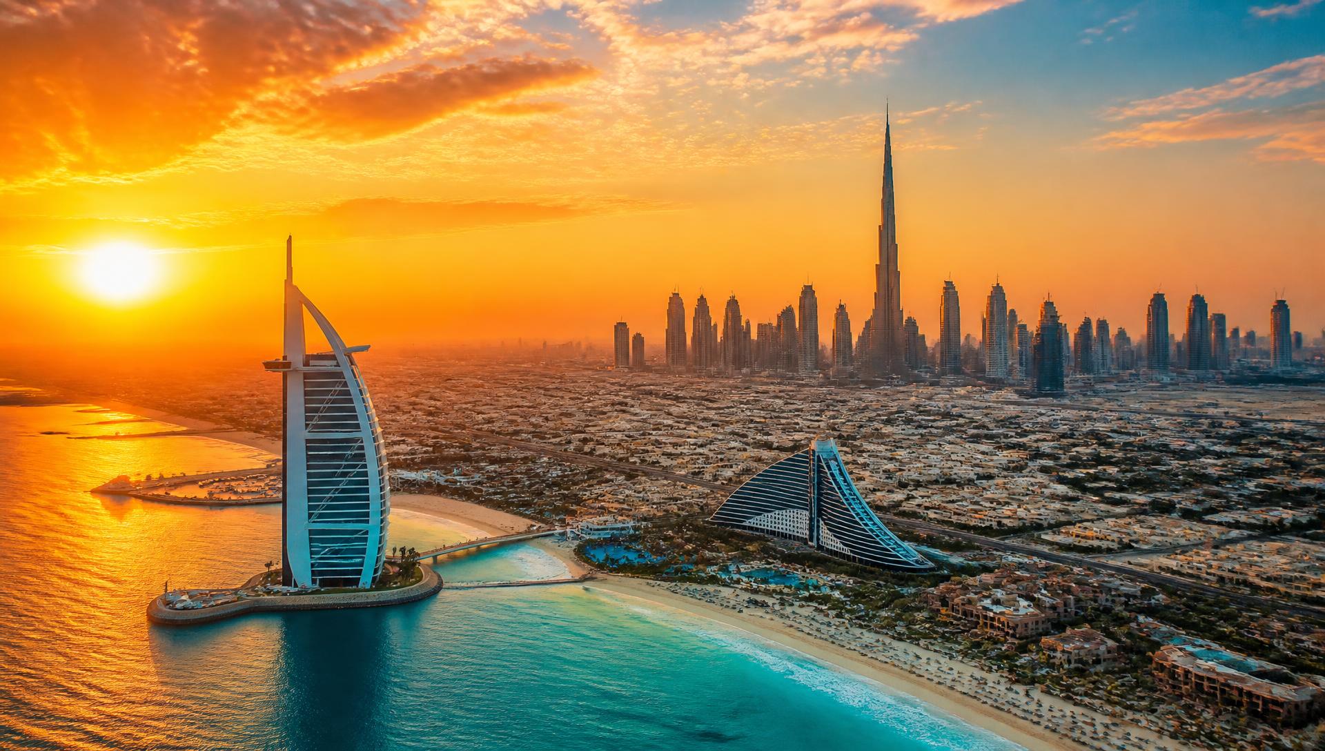 Aerial view of the Dubai coastline and skyline at golden sunset